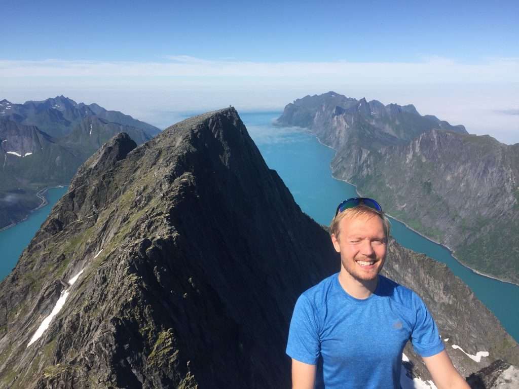 Man at top of the mountain Breitind at Senja