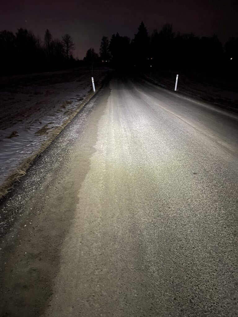 Petzl Iko Core Max Power beam lighting up an unlit country road
